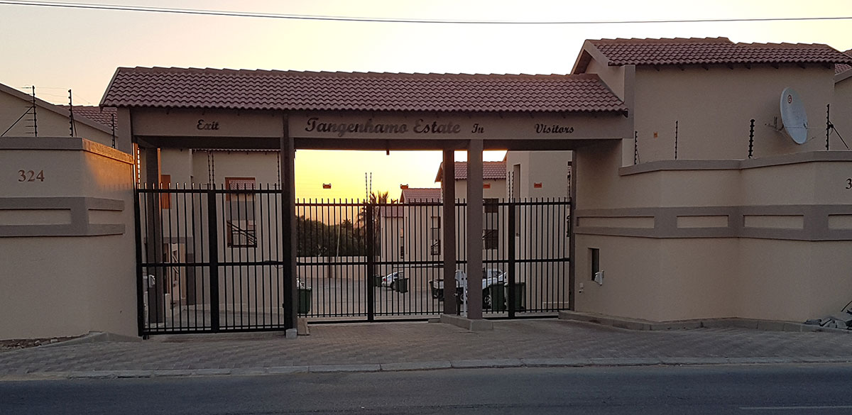 The gated entrance to Tangenhamo Estate at golden hour, a residential development by Tangenhamo Properties.